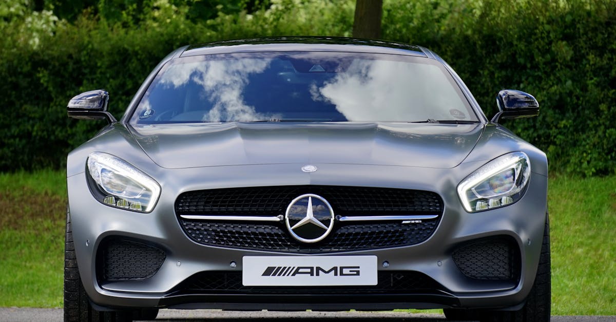 Front view of a luxury Mercedes-Benz AMG against a natural backdrop.