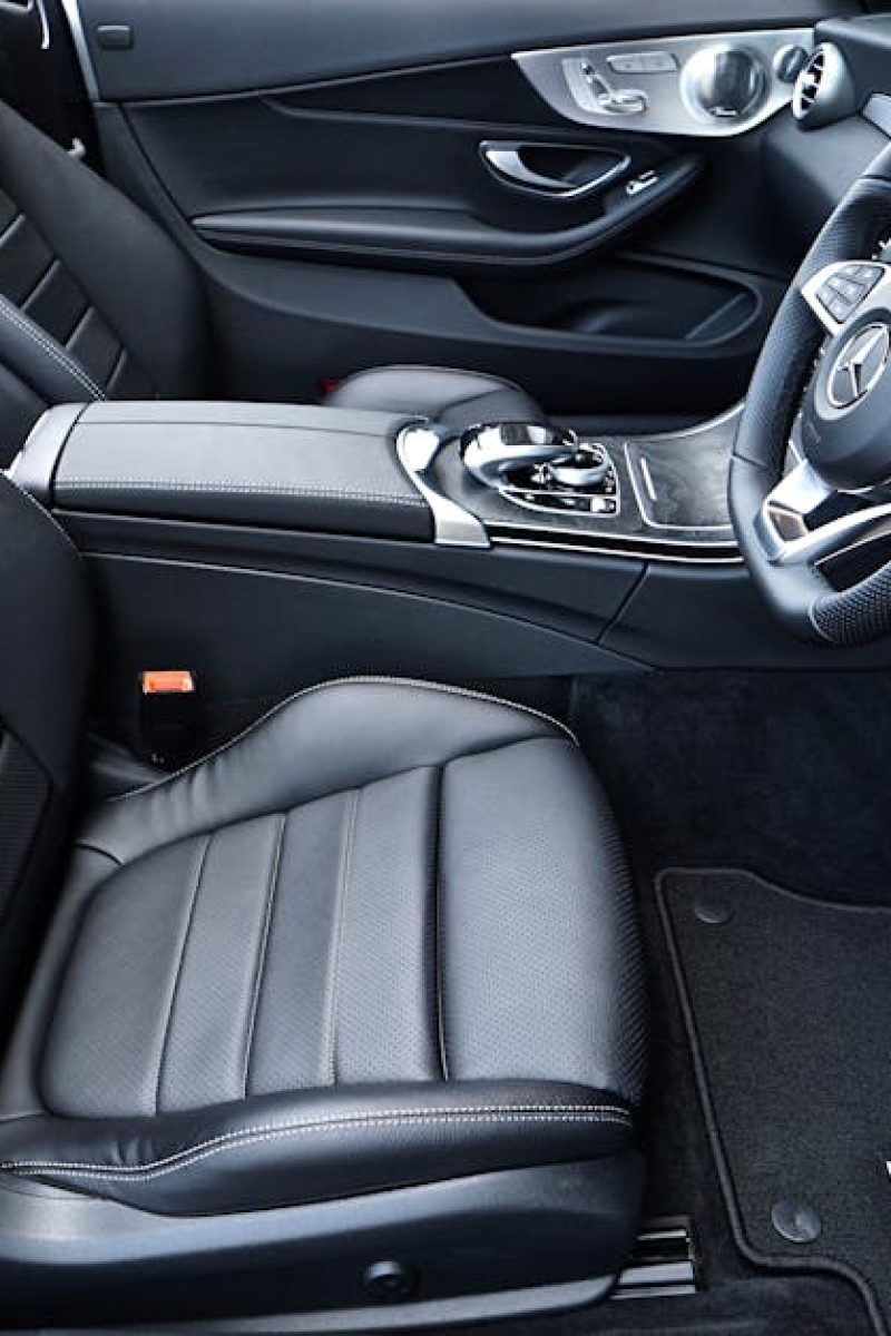 Sleek black Mercedes-Benz interior featuring leather seats and modern dashboard design.