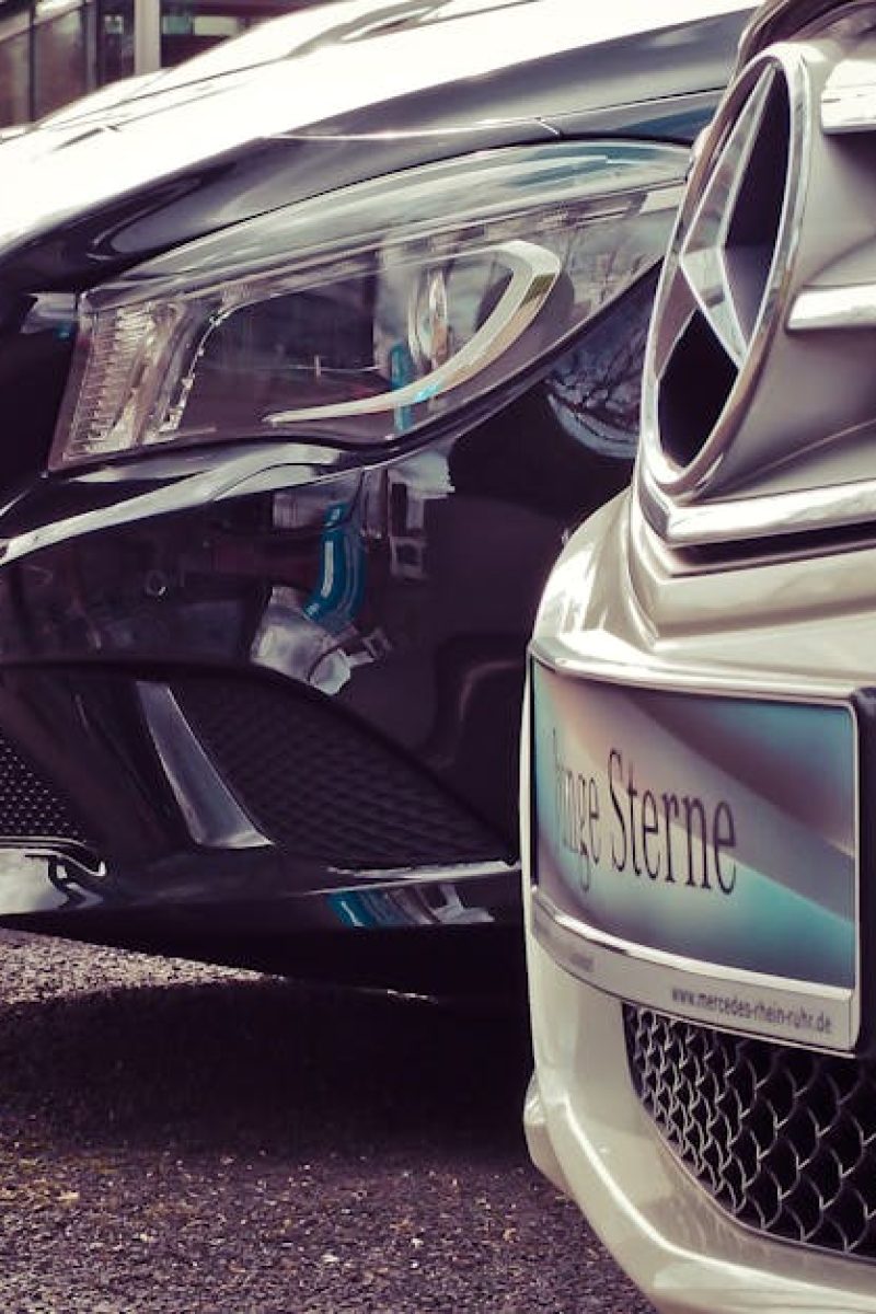 Luxury cars lined up at an outdoor dealership, showcasing sleek designs.