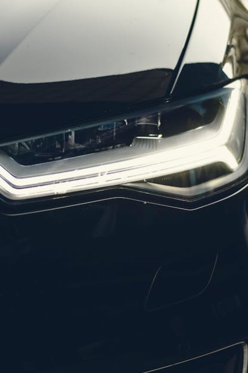 A sleek, modern luxury car showcasing its chrome detailing and LED headlights on a city street.